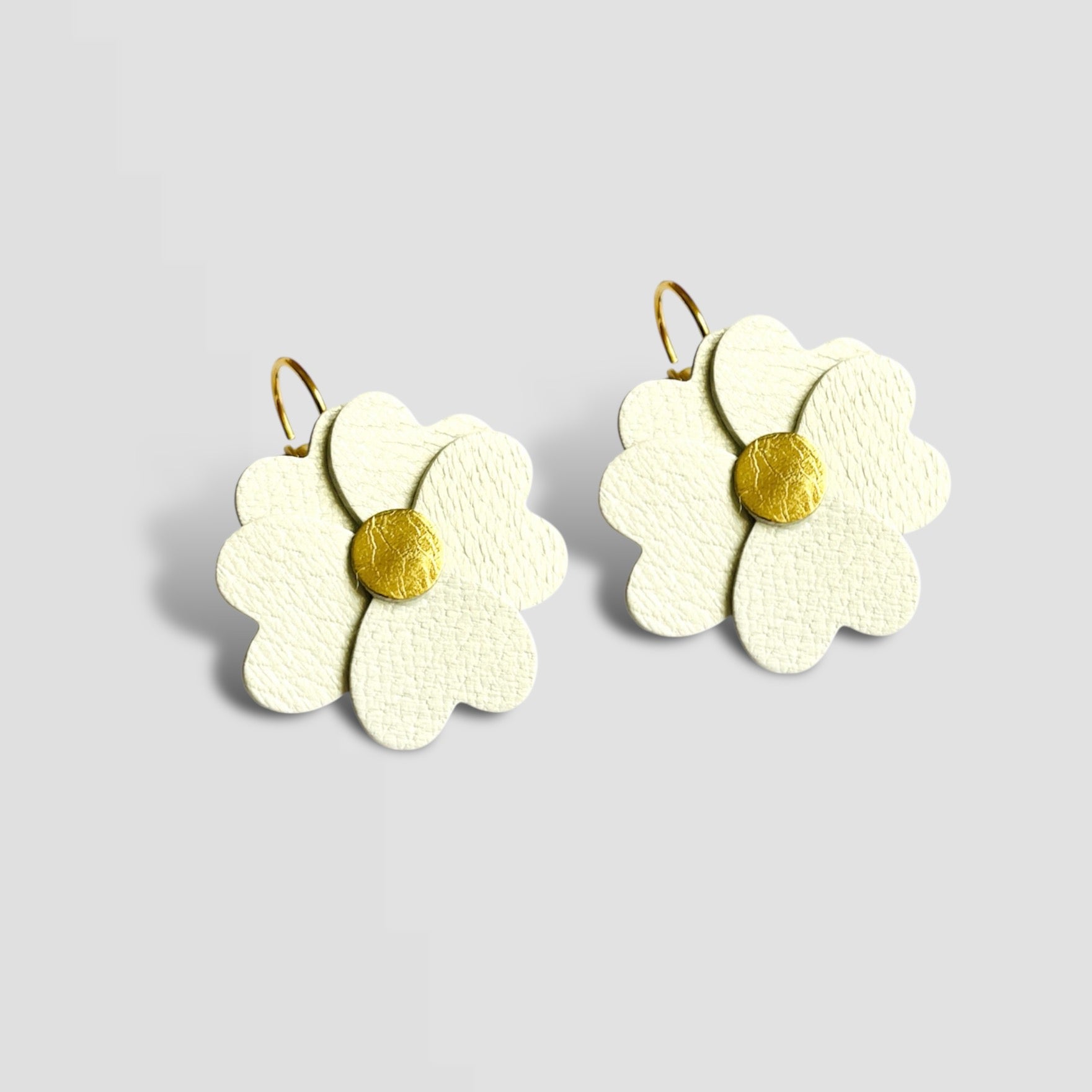 Boucles d'oreilles Nune en forme de petites fleurs , modèle Lalie, en cuirs blanc cassé nacré & doré, sur fond blanc