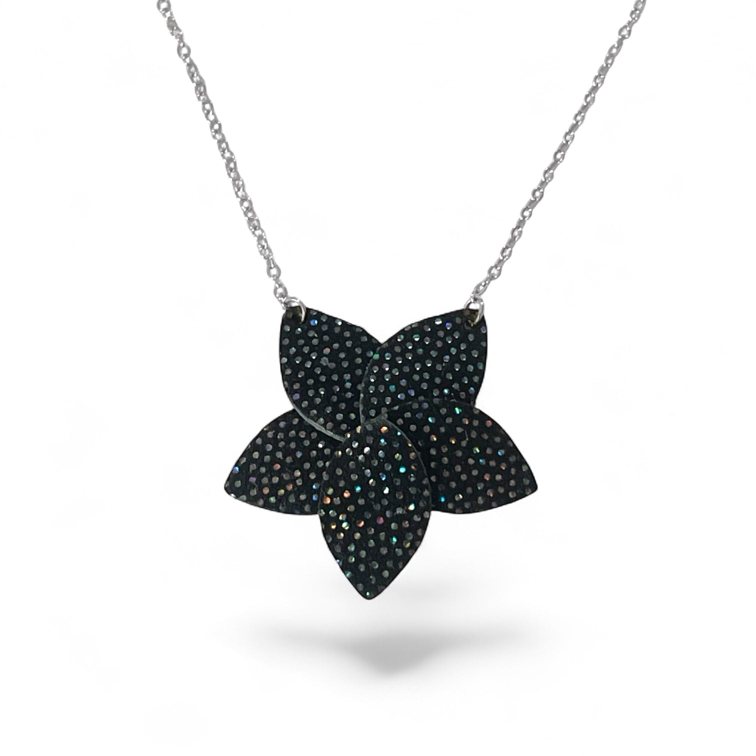 Collier argenté court avec pendentif en cuir noir à pois holographiques en forme de fleur, sur fond blanc