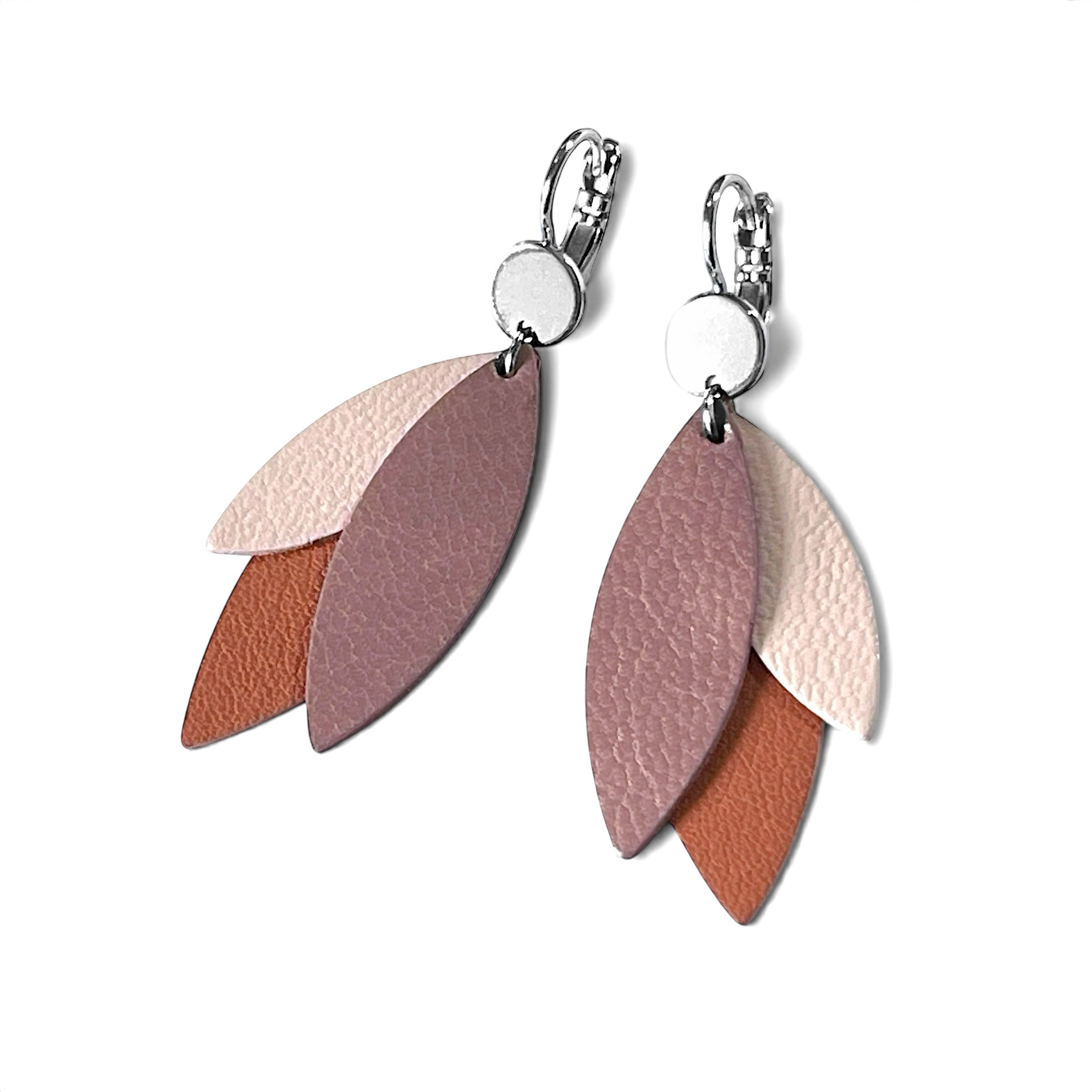 Boucles d'oreilles pendantes argentées et plumes de cuir dans les tons rosés, sur fond blanc