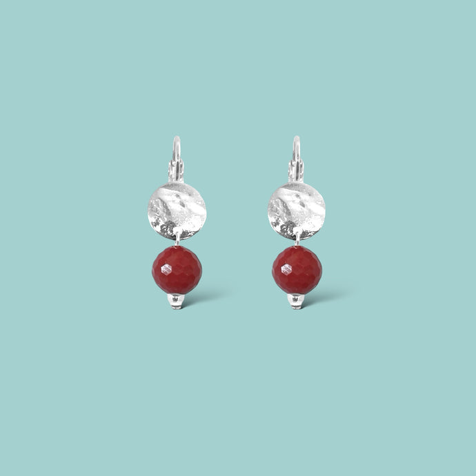 Petites boucles d'oreilles rondes en métal martelé doré à l'or fin avec pendant en perle de mokaïte bordeaux, sur fond vert pastel